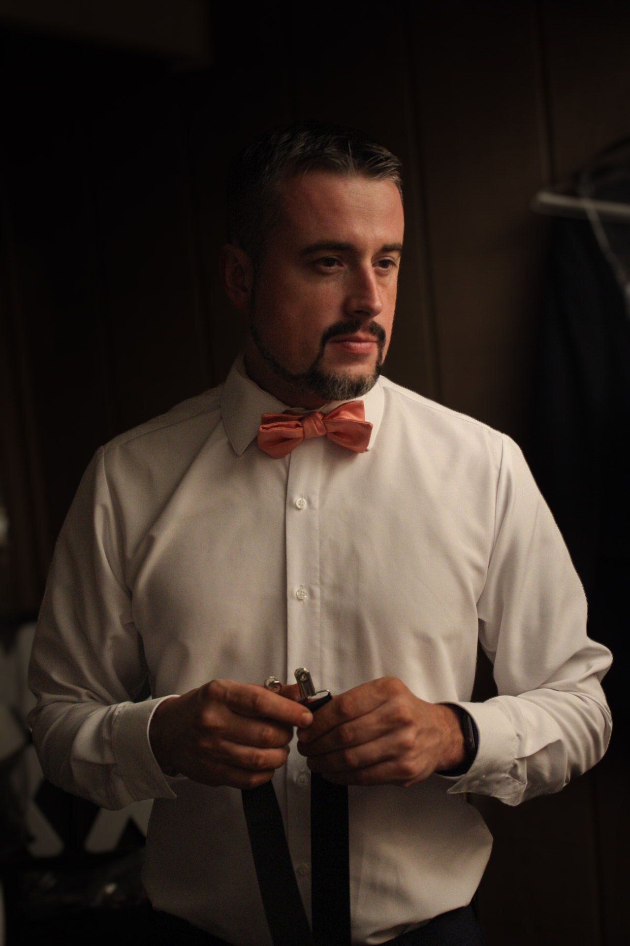 Emotional groom watching bride walk down aisle